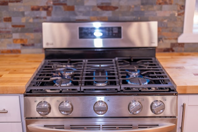 room details with stainless steel range and white cabinetry