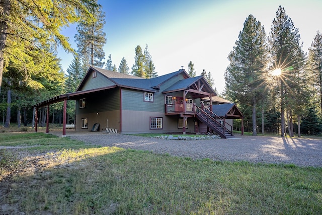 44 Copper Ridge Rd, Trout Creek, MT 59874 - rear view of property with a carport, a wooden deck, a lawn, and stairs