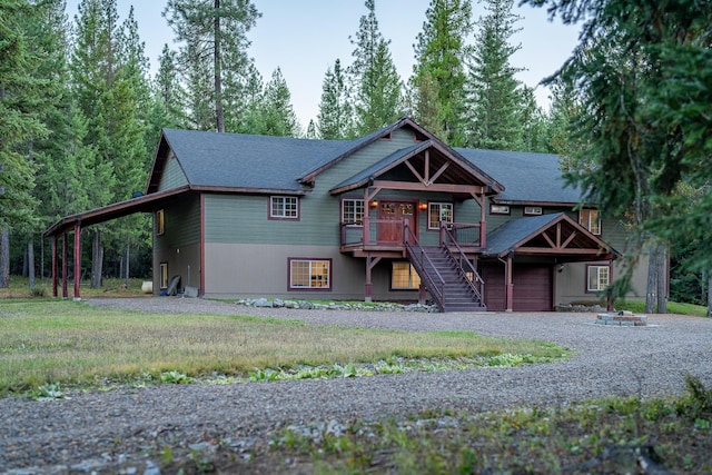 44 Copper Ridge Rd, Trout Creek, MT 59874 - view of front facade featuring a carport, gravel driveway, an attached garage, and stairway