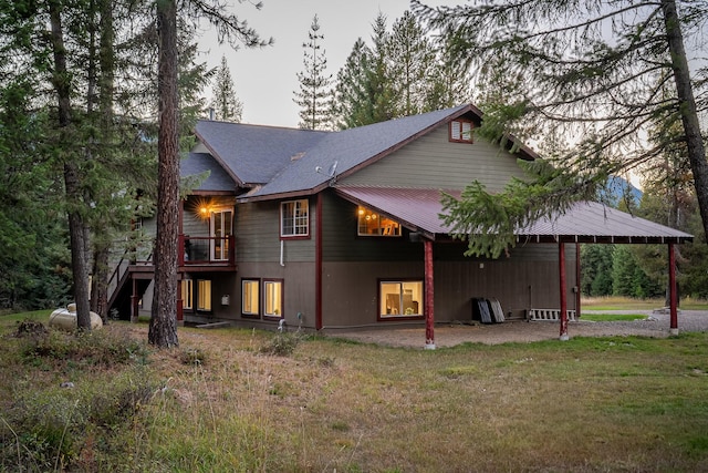 44 Copper Ridge Rd, Trout Creek, MT 59874 - back of house featuring a wooden deck, stairway, a yard, and an attached carport