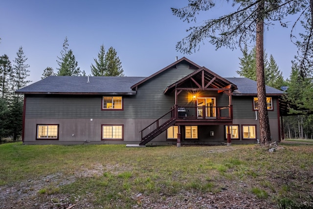 44 Copper Ridge Rd, Trout Creek, MT 59874 - back of property at dusk featuring a lawn, stairs, and a deck