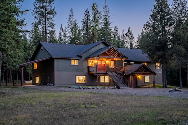 view of front of home with a deck and a yard