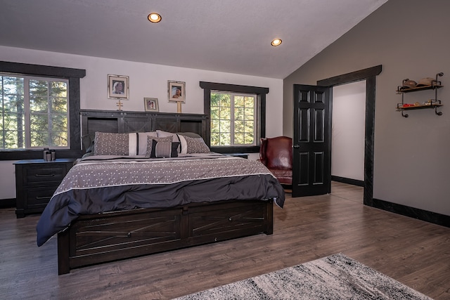 bedroom with vaulted ceiling and hardwood / wood-style flooring