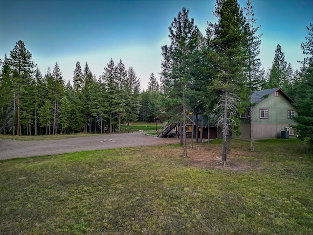44 Copper Ridge Rd, Trout Creek, MT 59874 - view of yard featuring central air condition unit, a wooded view, stairway, and driveway