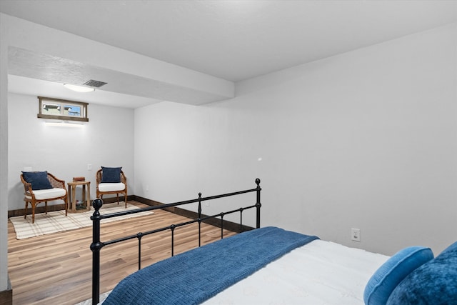 bedroom with wood-type flooring