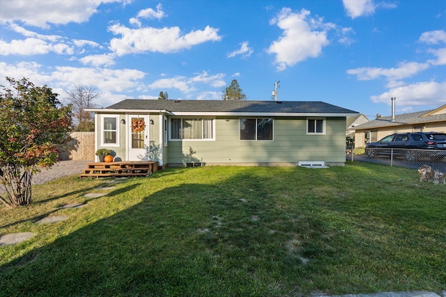 rear view of property with a lawn