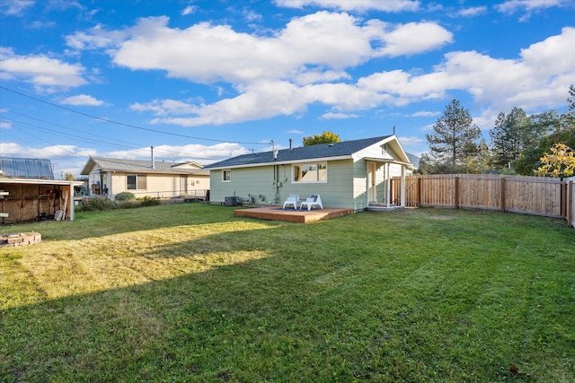 back of house featuring a yard and a deck