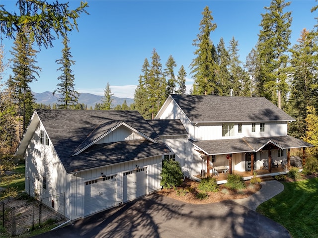 view of front facade with a mountain view, a garage, and a porch