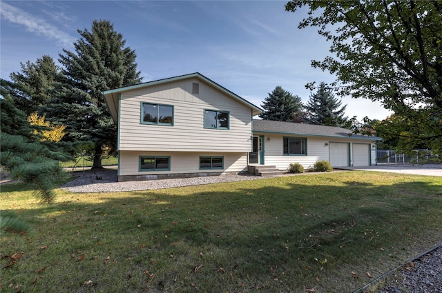 tri-level home featuring a front yard and a garage