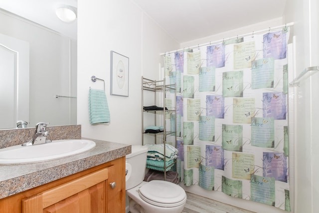 bathroom featuring wood-type flooring, vanity, toilet, and a shower with curtain