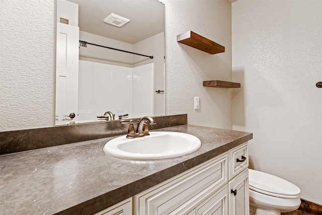 bathroom featuring vanity and toilet