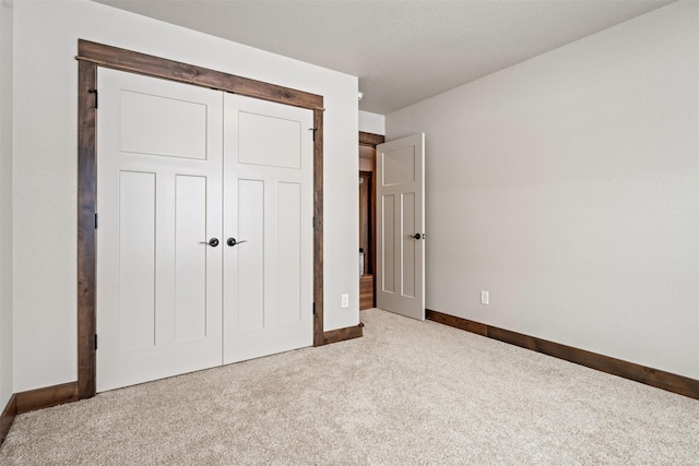 unfurnished bedroom featuring carpet flooring and a closet