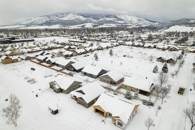 snowy aerial view featuring a mountain view