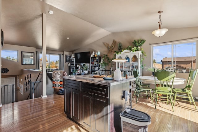 28 W Ashley Hills Dr, Kalispell, MT 59901 - kitchen with light wood-type flooring, lofted ceiling, healthy amount of natural light, open floor plan, and pendant lighting