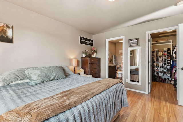 28 W Ashley Hills Dr, Kalispell, MT 59901 - bedroom featuring a walk in closet, light wood-style flooring, baseboards, and a closet
