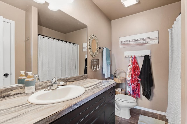 28 W Ashley Hills Dr, Kalispell, MT 59901 - bathroom with toilet, vanity, tile patterned floors, and baseboards