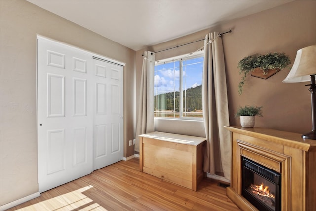 28 W Ashley Hills Dr, Kalispell, MT 59901 - sitting room featuring light wood-type flooring, a glass covered fireplace, and baseboards