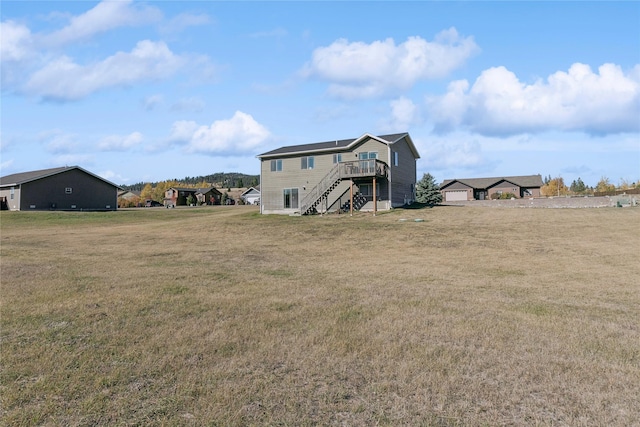 28 W Ashley Hills Dr, Kalispell, MT 59901 - rear view of house with stairs, a wooden deck, and a lawn
