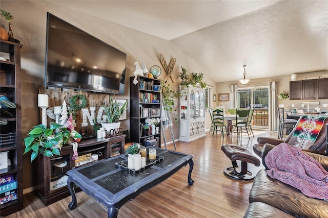 28 W Ashley Hills Dr, Kalispell, MT 59901 - living area featuring vaulted ceiling, wood finished floors, and baseboards
