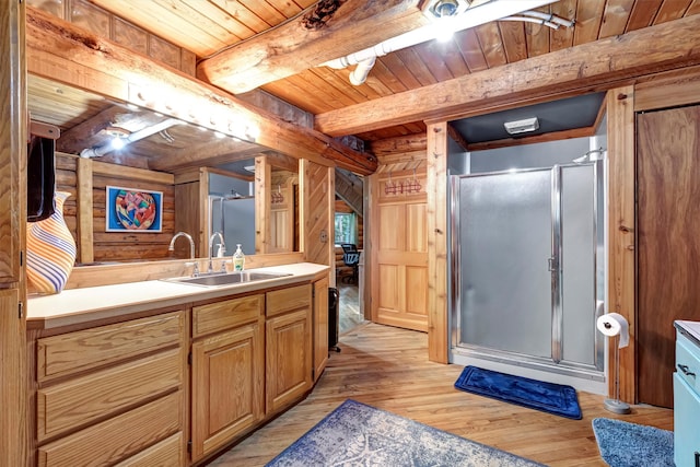 bathroom with hardwood / wood-style floors, beamed ceiling, wooden ceiling, and walk in shower