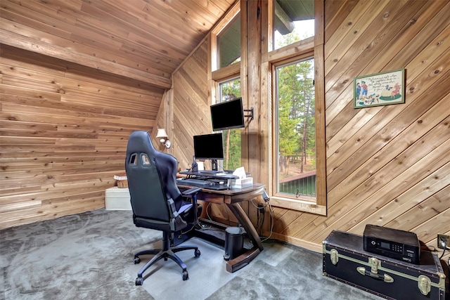 office area featuring carpet flooring, vaulted ceiling, wooden ceiling, and wood walls