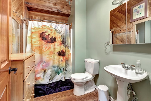 bathroom featuring a shower with shower curtain, wood-type flooring, and toilet