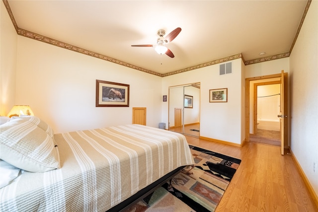 bedroom with wood-type flooring, a closet, ornamental molding, and ceiling fan