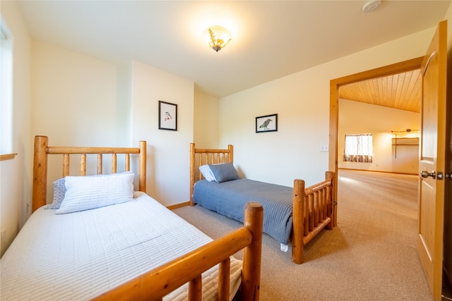 bedroom with lofted ceiling and light colored carpet