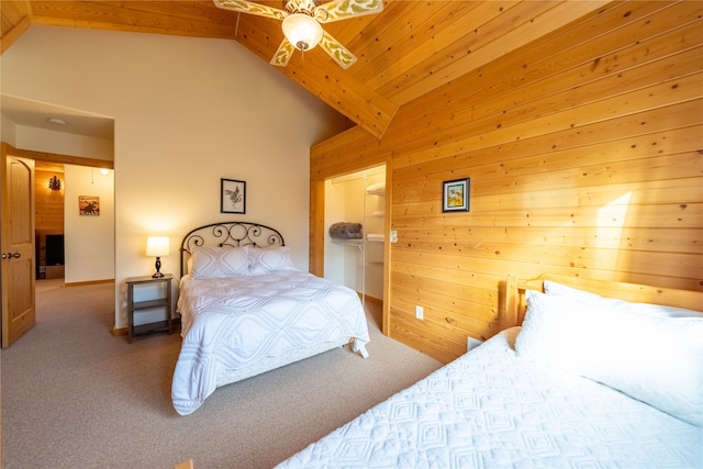 carpeted bedroom featuring ceiling fan, wood walls, and high vaulted ceiling