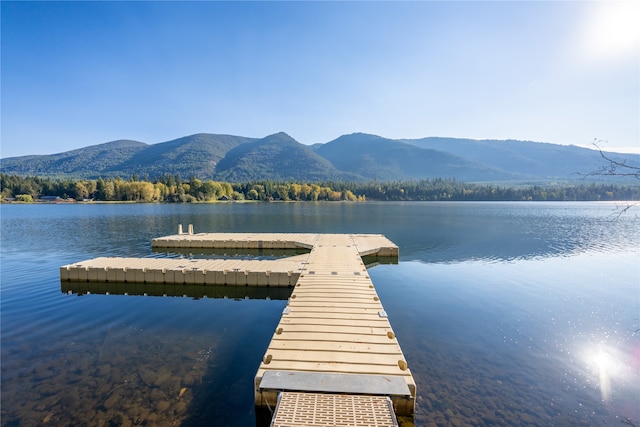 view of dock with a water and mountain view