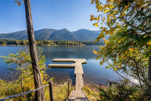 view of dock with a water and mountain view