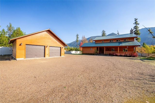 exterior space featuring a porch, wooden walls, and a mountain view