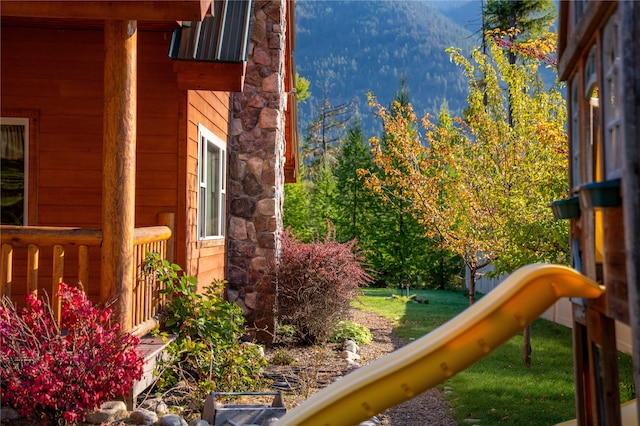 exterior space with a playground and a yard