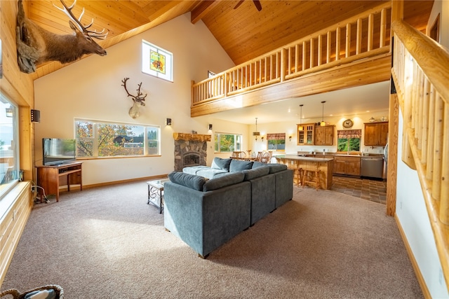 carpeted living room featuring a fireplace, wood ceiling, beam ceiling, and high vaulted ceiling