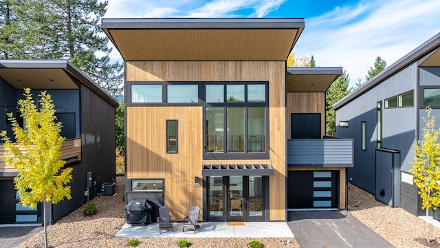 contemporary house featuring cooling unit and a patio