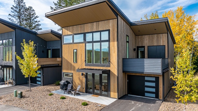 back of house featuring a garage