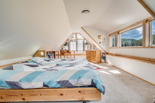 bedroom featuring lofted ceiling, multiple windows, and carpet floors