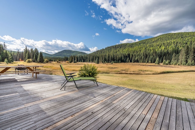 deck featuring a yard and a mountain view