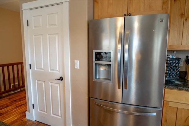 kitchen with stainless steel refrigerator with ice dispenser, dark hardwood / wood-style flooring, and light brown cabinets