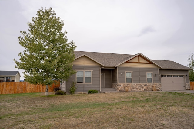 view of front of home with a front yard and a garage