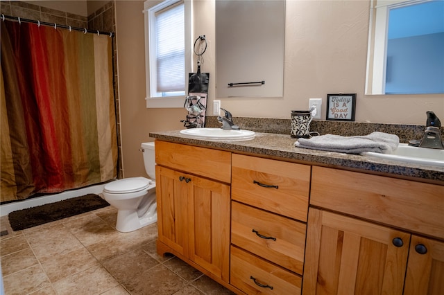 bathroom with tile patterned flooring, vanity, toilet, and a shower with shower curtain