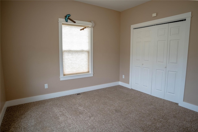 unfurnished bedroom featuring carpet floors and a closet