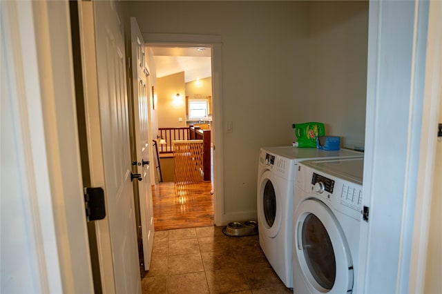 clothes washing area featuring hardwood / wood-style flooring and washing machine and clothes dryer