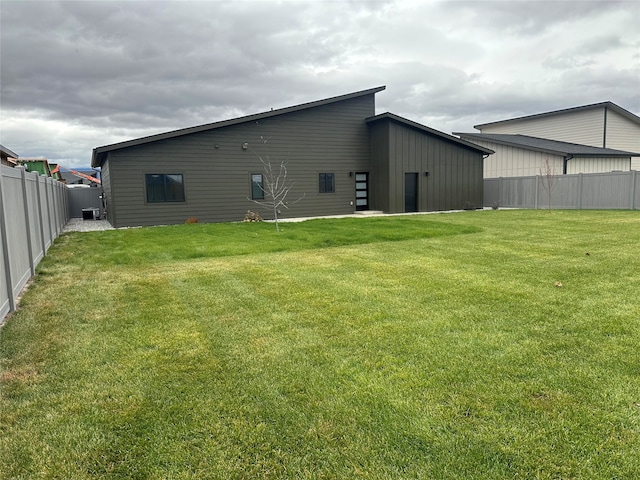 rear view of property with a lawn