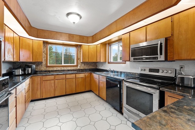 kitchen with sink, decorative backsplash, and black appliances