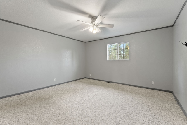 carpeted empty room featuring ceiling fan and a textured ceiling