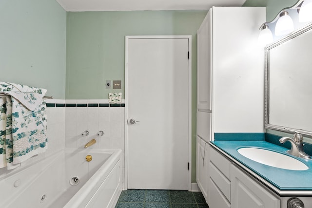 bathroom with tile patterned flooring, a tub to relax in, and vanity