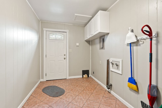 washroom featuring washer hookup, ornamental molding, cabinets, and wooden walls