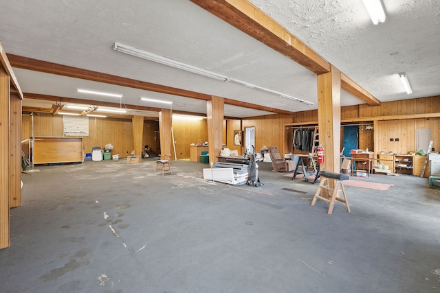 interior space featuring wooden walls and a textured ceiling