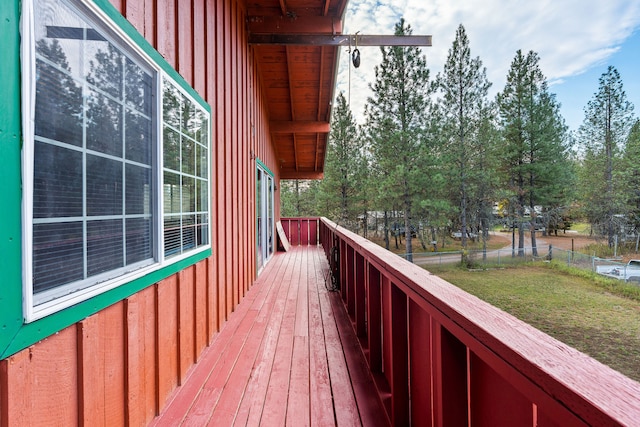 wooden deck featuring a yard